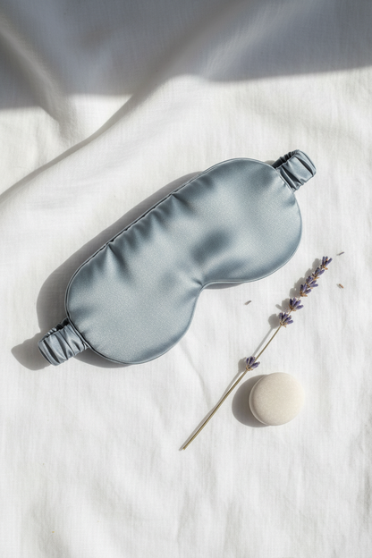 Bluish grey silk eye mask flat lay with lavender